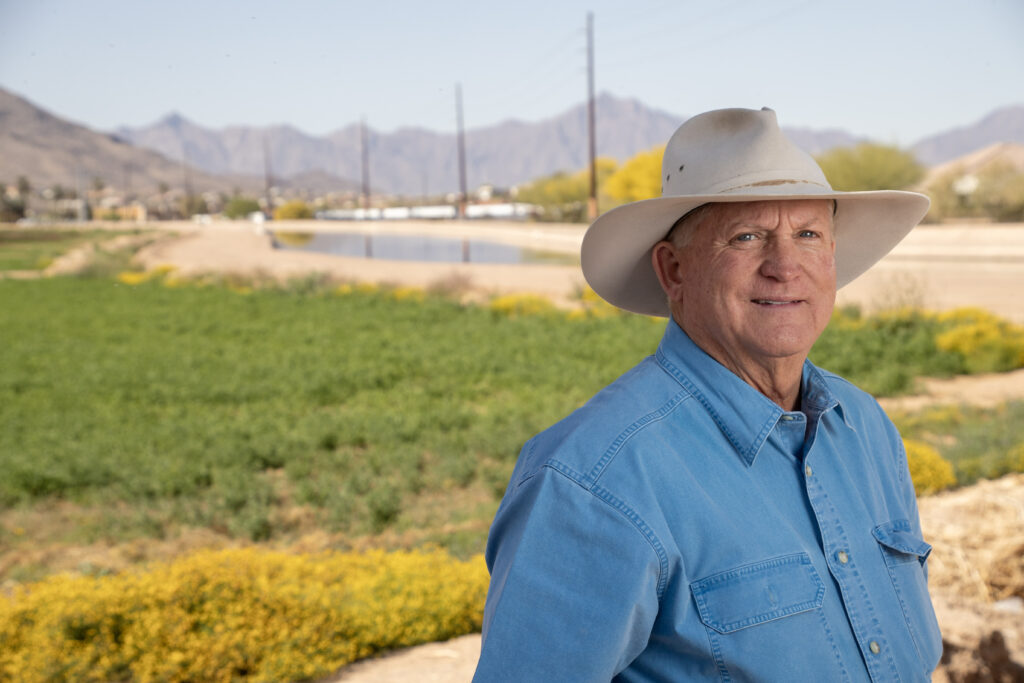 Stephen H. Williams stands in front of his farm in South Phoenix, showcasing his deep roots in Arizona agriculture.